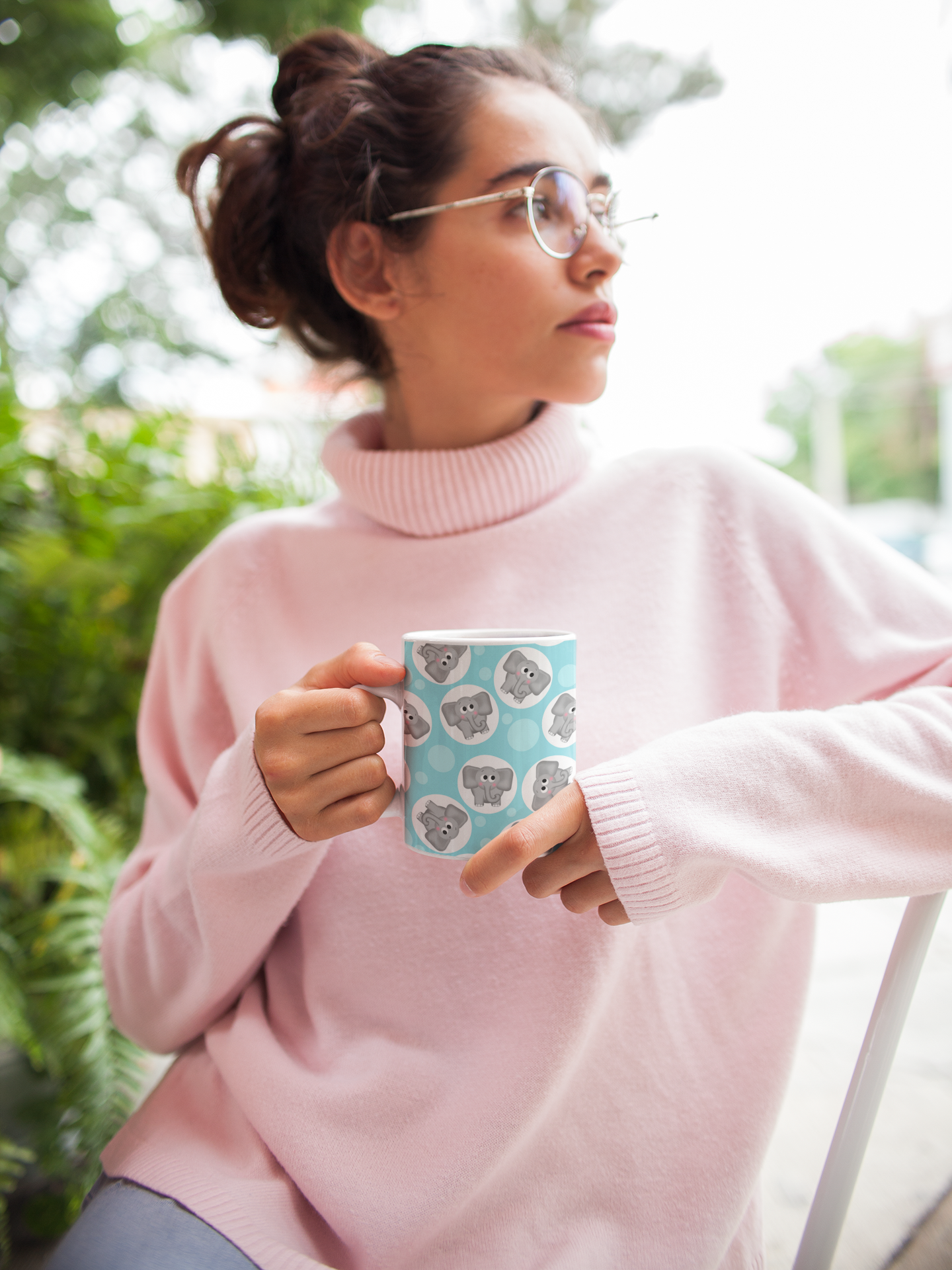 Girl holding the turquoise elephant pattern mug at Amy's Coffee Mugs