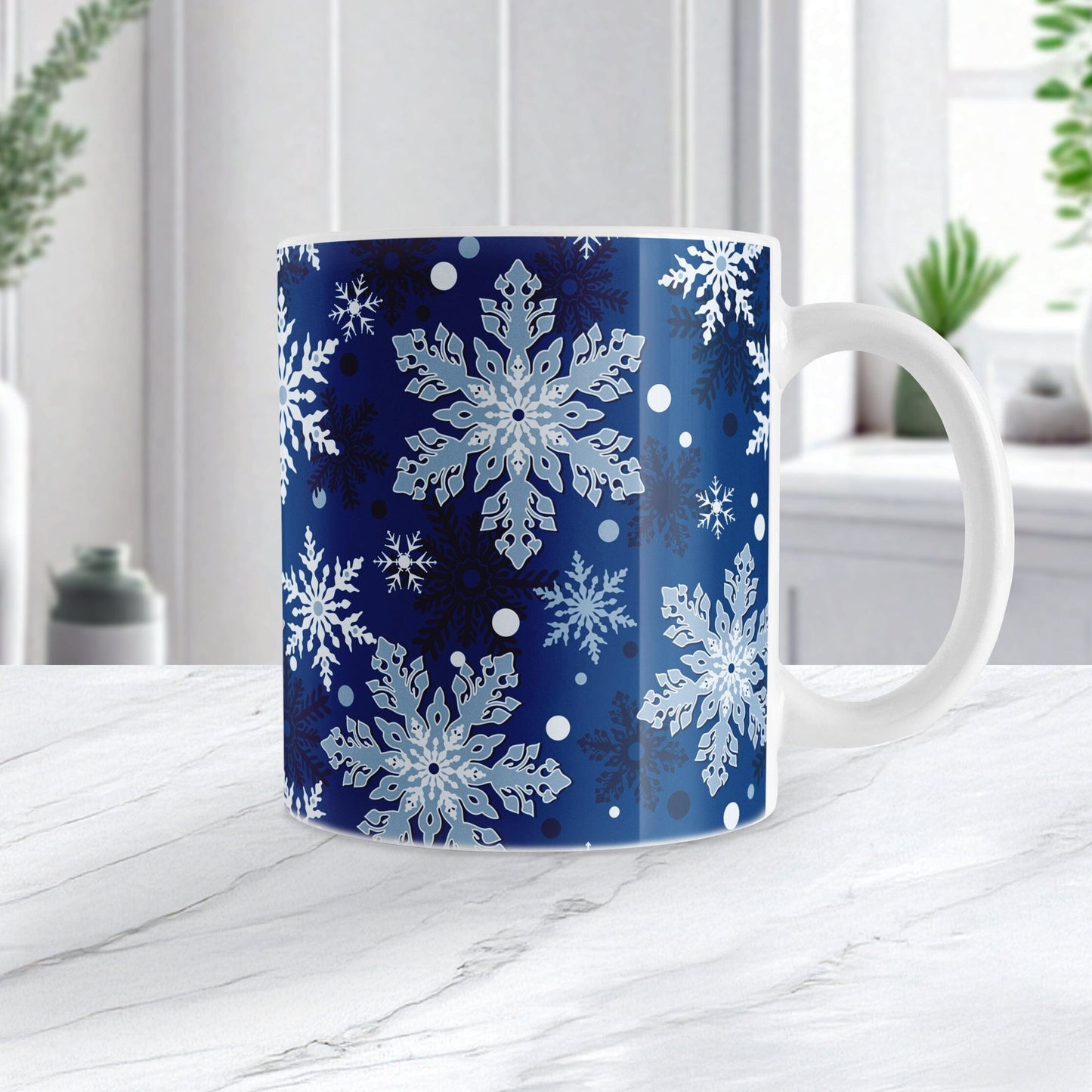 Mug with snowflake pattern on a blue background, placed on a white surface.