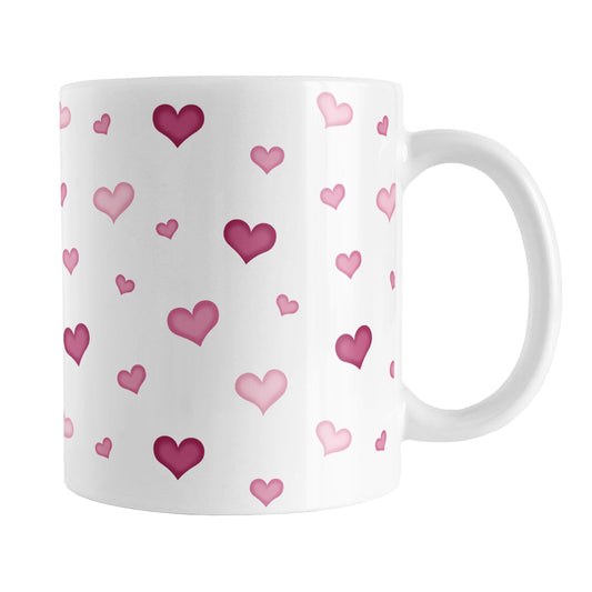 Dainty Cute Pink Hearts Mug (11oz) at Amy's Coffee Mugs. A ceramic coffee mug designed with a print of cute and dainty hand-drawn pink hearts in different shades of pink in a pattern that wraps around the mug up to the handle.