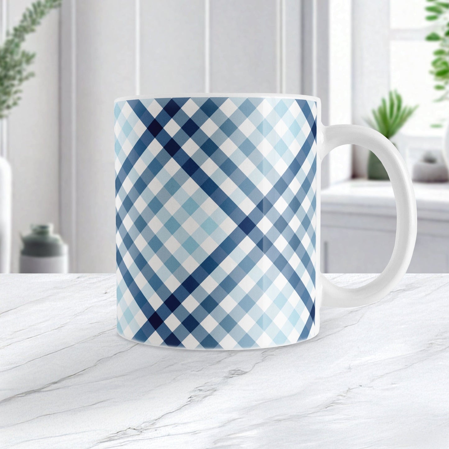 Gradient Blue Gingham Mug (11oz) at Amy's Coffee Mugs. A ceramic mug with a stepped gradient blue gingham pattern that wraps around the mug up to the handle. It's a modern take on a classic black and white check pattern with blue tones progressing from navy blue to light blue. Image shows the mug on a white marble countertop.