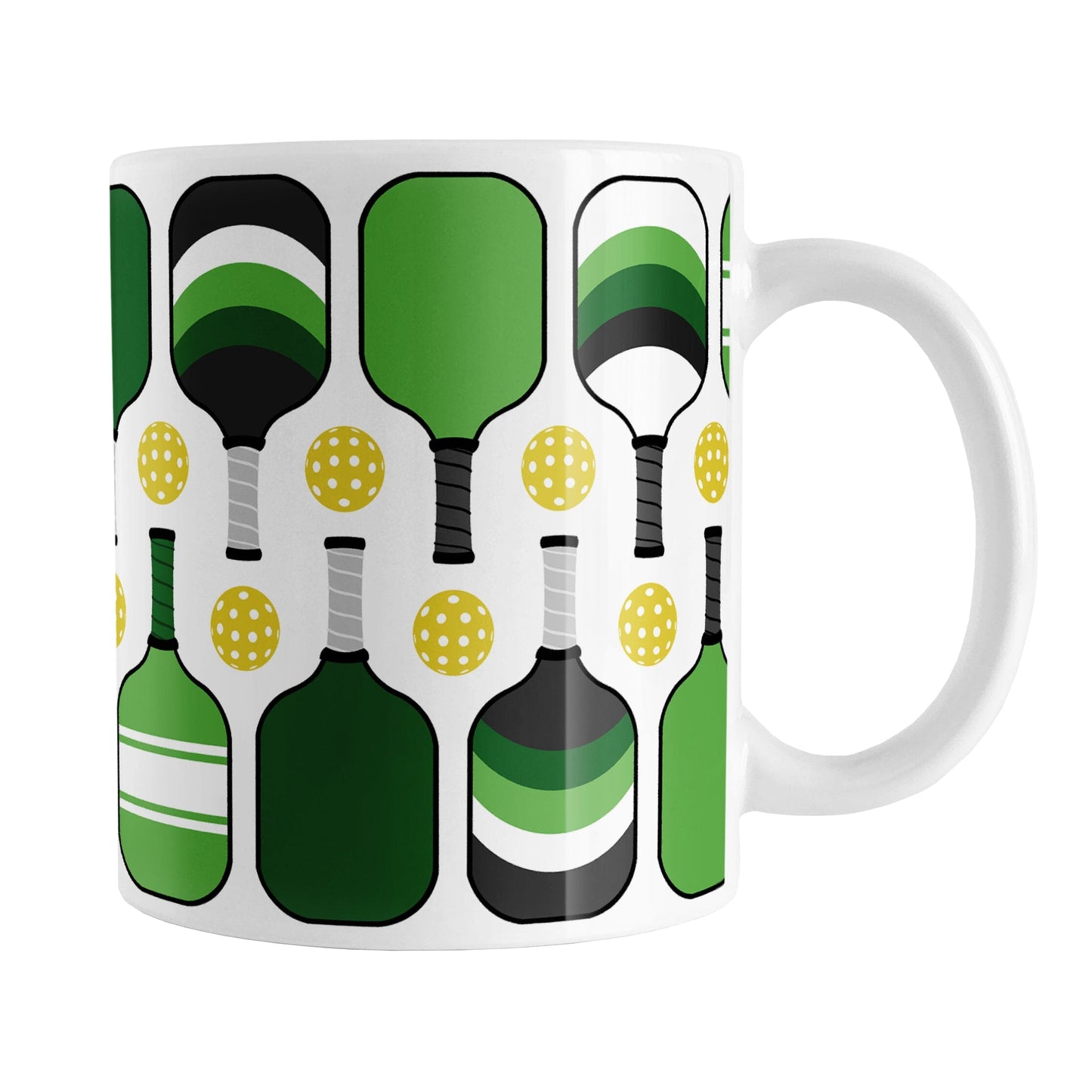 Green Pickleball Mug (11oz) at Amy's Coffee Mugs. A ceramic coffee mug designed with modern green pickleball paddles and yellow balls in a pattern that wraps around the mug up to the handle.