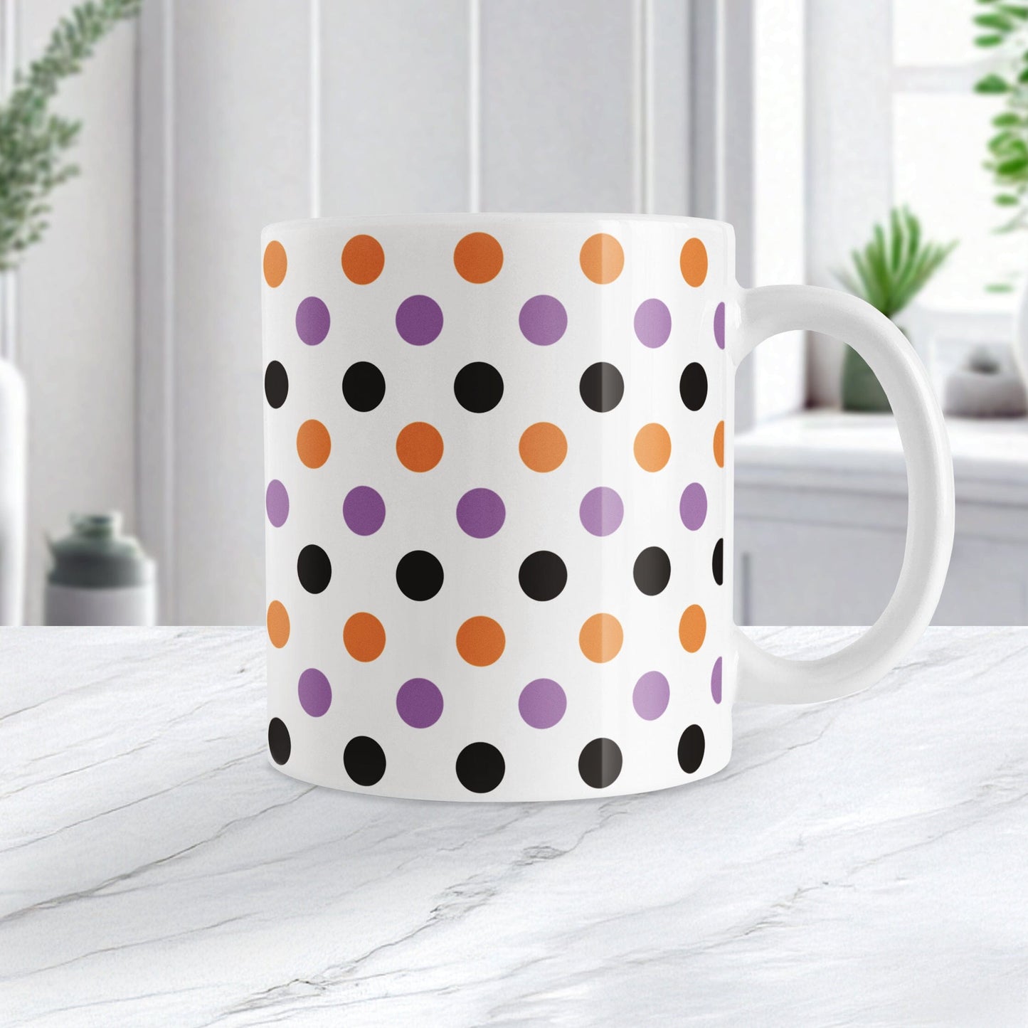 White mug with colorful polka dot pattern in orange, purple, and black, perfect for Halloween. Photo shows the mug on a marble tabletop.