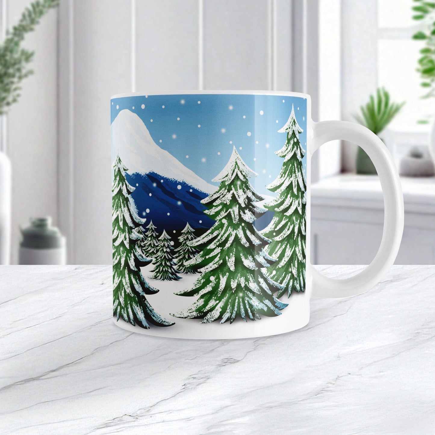 Mug with a winter scene of trees and snow on a white countertop