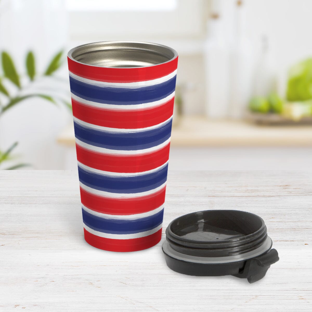 Patriotic Paint Brush Strokes Travel Mug (15oz) at Amy's Coffee Mugs. A stainless steel travel mug featuring a print of artistic paint brush strokes horizontally across the travel mug, in alternating colors of red and blue over white to celebrate the 4th of July (Independence Day) holiday. Image shows the mug open with the lid beside it.