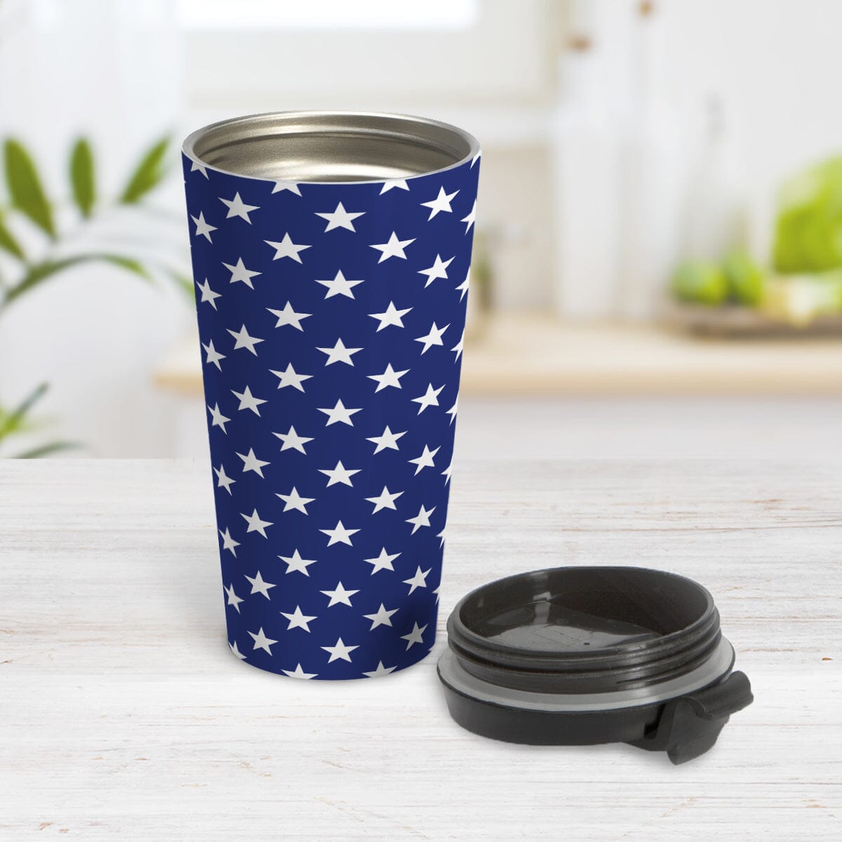 Patriotic White Stars on Blue Travel Mug (15oz) at Amy's Coffee Mugs. A stainless steel travel mug with white stars in a pattern over a blue background that wraps around the travel mug. It's been design for 4th of July (Independence Day) celebrations and everyday use. Photo shows the mug open with the lid beside it.
