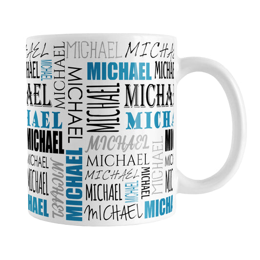 Personalized Blue Name Collage Mug (11oz) at Amy's Coffee Mugs. A ceramic coffee mug designed with your personalized medium-length name in different fonts, running both horizontally and vertically in blue, black, and gray, in a pattern that wraps around the mug up to the handle.