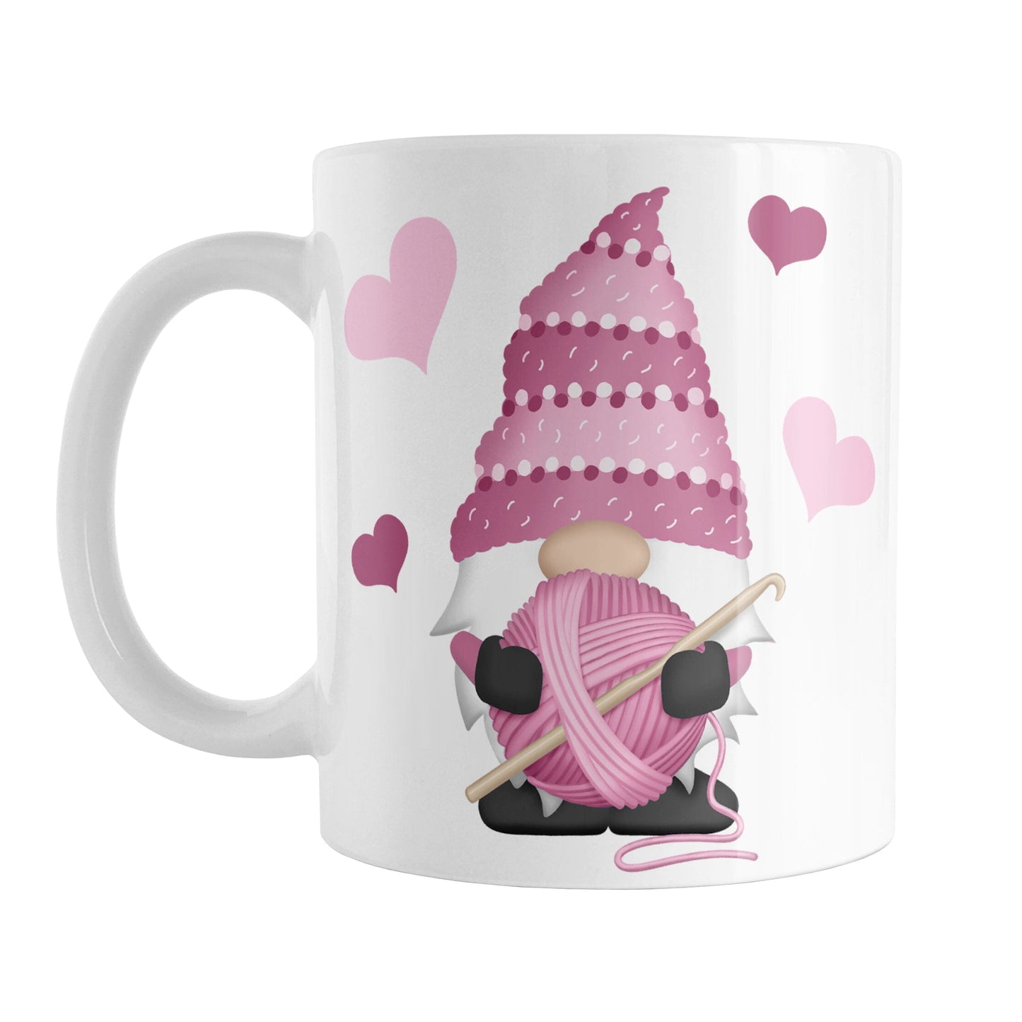 Pink Crochet Gnome Mug (11oz) at Amy's Coffee Mugs. A ceramic coffee mug designed with a cute gnome wearing a pink crochet hat while holding a ball of pink yarn and a crochet hook with pink hearts around him. This adorable crochet gnome illustration is on both sides of the mug.