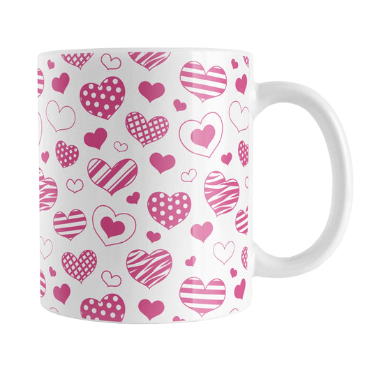 Pink Heart Doodles Mug (11oz) at Amy's Coffee Mugs. A ceramic coffee mug designed with hand-drawn pink heart doodles in a pattern that wraps around the cup. This cute heart pattern is perfect for Valentine's Day or for anyone who loves hearts and young-at-heart drawings.