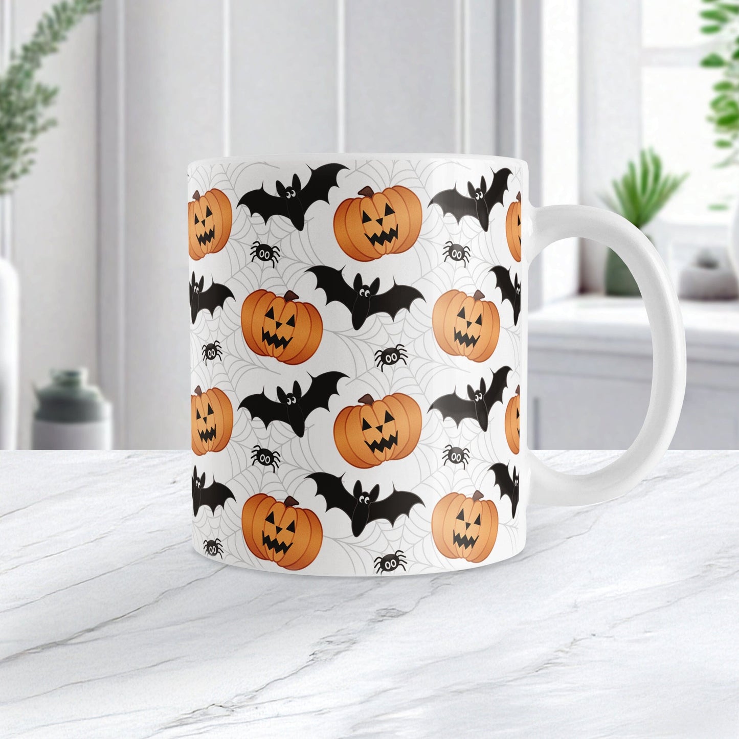11oz mug with Halloween-themed design featuring pumpkins, bats, and spiders on a white marble surface.