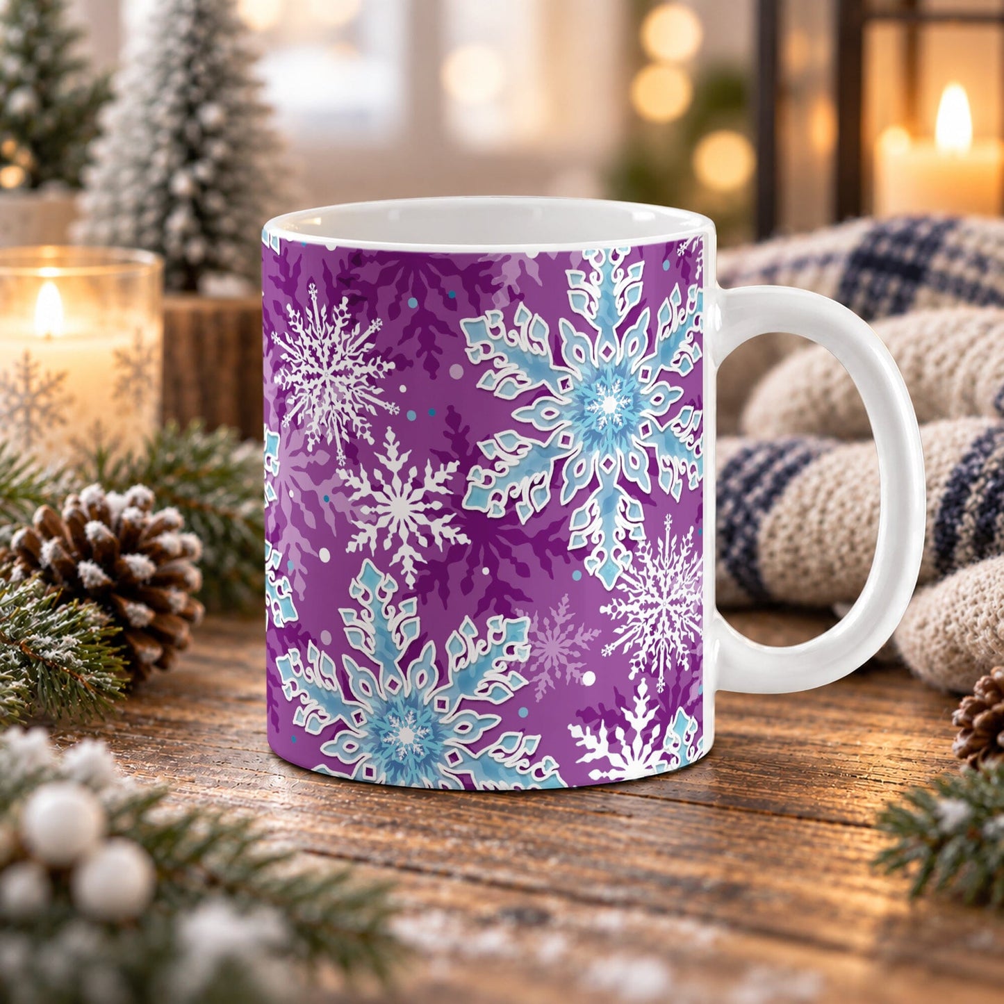 11 oz purple winter mug with large aqua blue and white snowflakes, dark purple snowflakes, and smaller accents across the pattern, shown on a wooden table with winter decor around it.