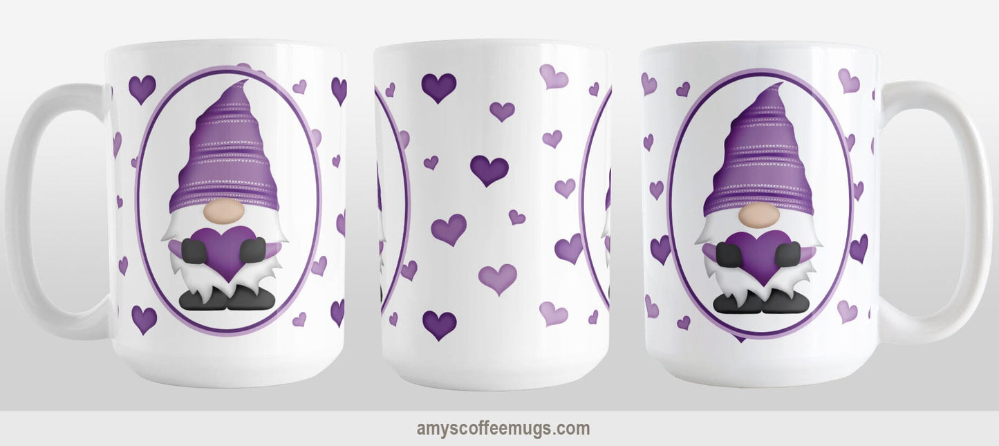 Purple Gnome Dainty Hearts Mug (15oz) at Amy's Coffee Mugs. A ceramic coffee mug designed with an adorable purple gnome in a white oval on both sides of the mug over a pattern of cute dainty hearts in different shades of purple that wrap around the mug to the handle. Photo shows three sides of the mug to show the entire printed design.