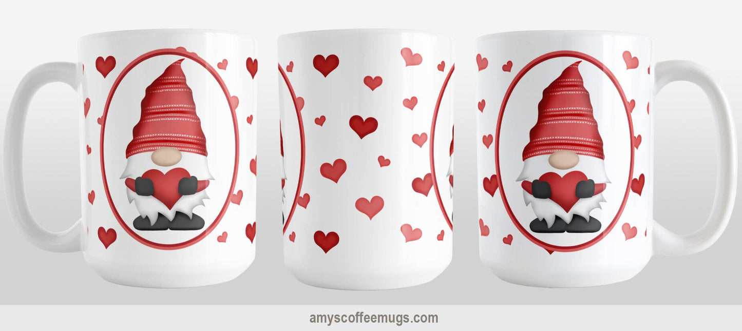 Red Gnome Dainty Hearts Mug (15oz) at Amy's Coffee Mugs. A ceramic coffee mug designed with an adorable red gnome in a white oval on both sides of the mug over a pattern of cute dainty hearts in different shades of red that wrap around the mug to the handle. Photo shows three sides of the mug so that you can see the entire printed design.