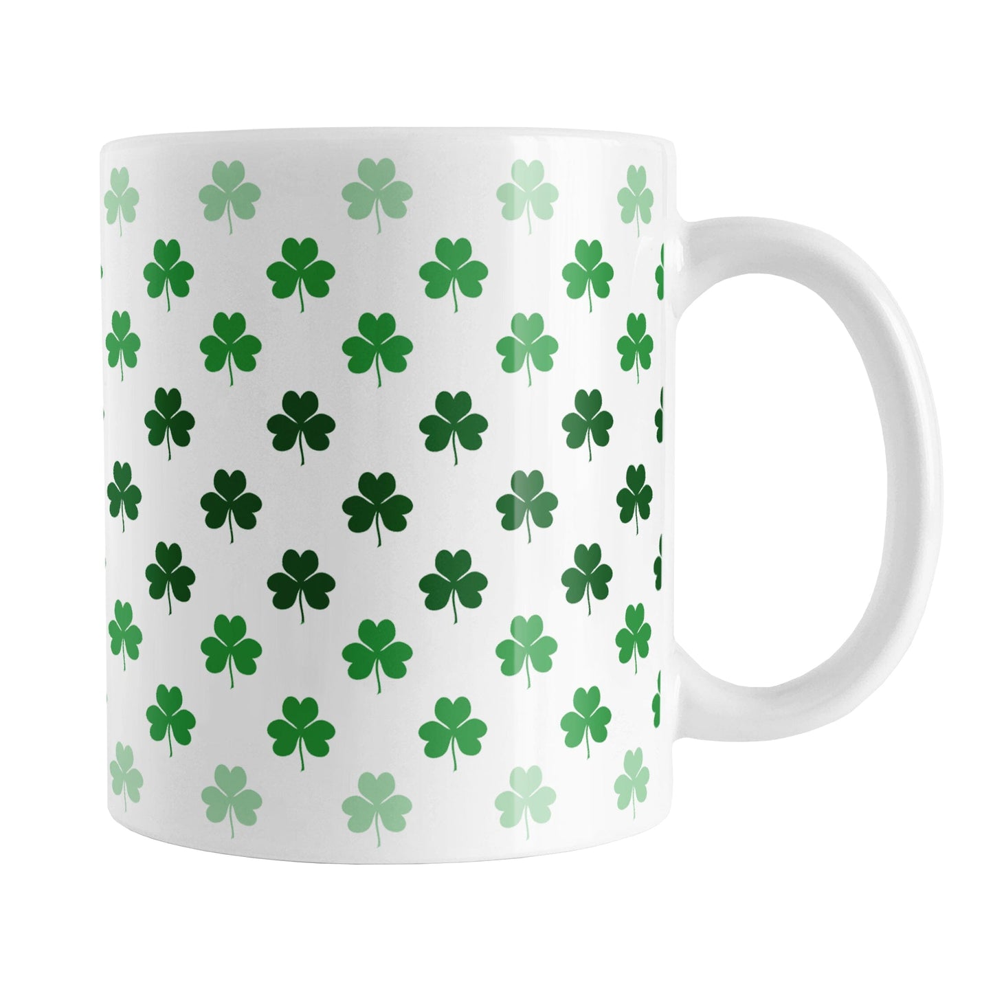 Shamrocks in Green Mug (11oz) at Amy's Coffee Mugs. A ceramic coffee mug designed with shamrocks (or clovers) in different shades of green, with the darker green color across the middle and the lighter green along the top and bottom, in a pattern that wraps around the mug to the handle.