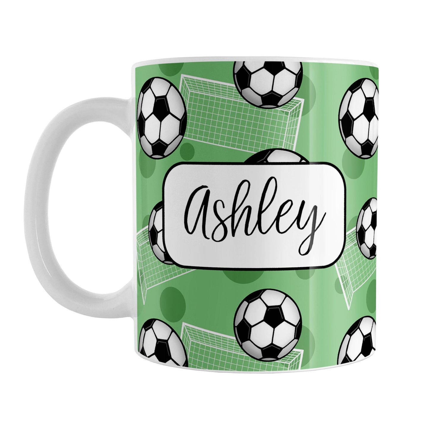 Soccer Ball and Goal Personalized Green Soccer Mug (11oz) at Amy's Coffee Mugs. A ceramic coffee mug designed with a pattern of soccer balls and white soccer goals over a green background with green circles. Your personalized name is custom-printed in a fun black script font on both sides of the mug over the soccer pattern.