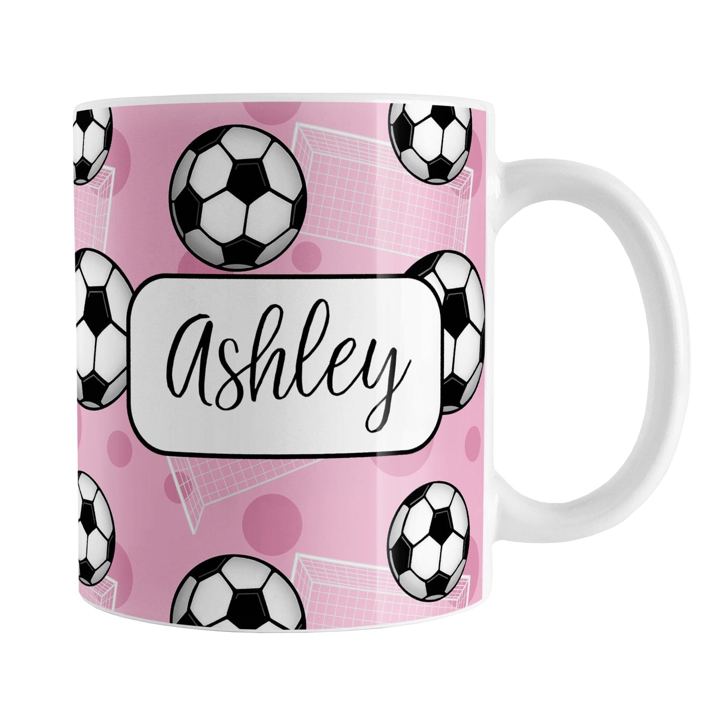 Soccer Ball and Goal Personalized Pink Soccer Mug (11oz) at Amy's Coffee Mugs. A ceramic coffee mug designed with a pattern of soccer balls and white soccer goals over a pink background with pink circles. Your personalized name is custom-printed in a fun black script font on both sides of the mug over the soccer pattern.