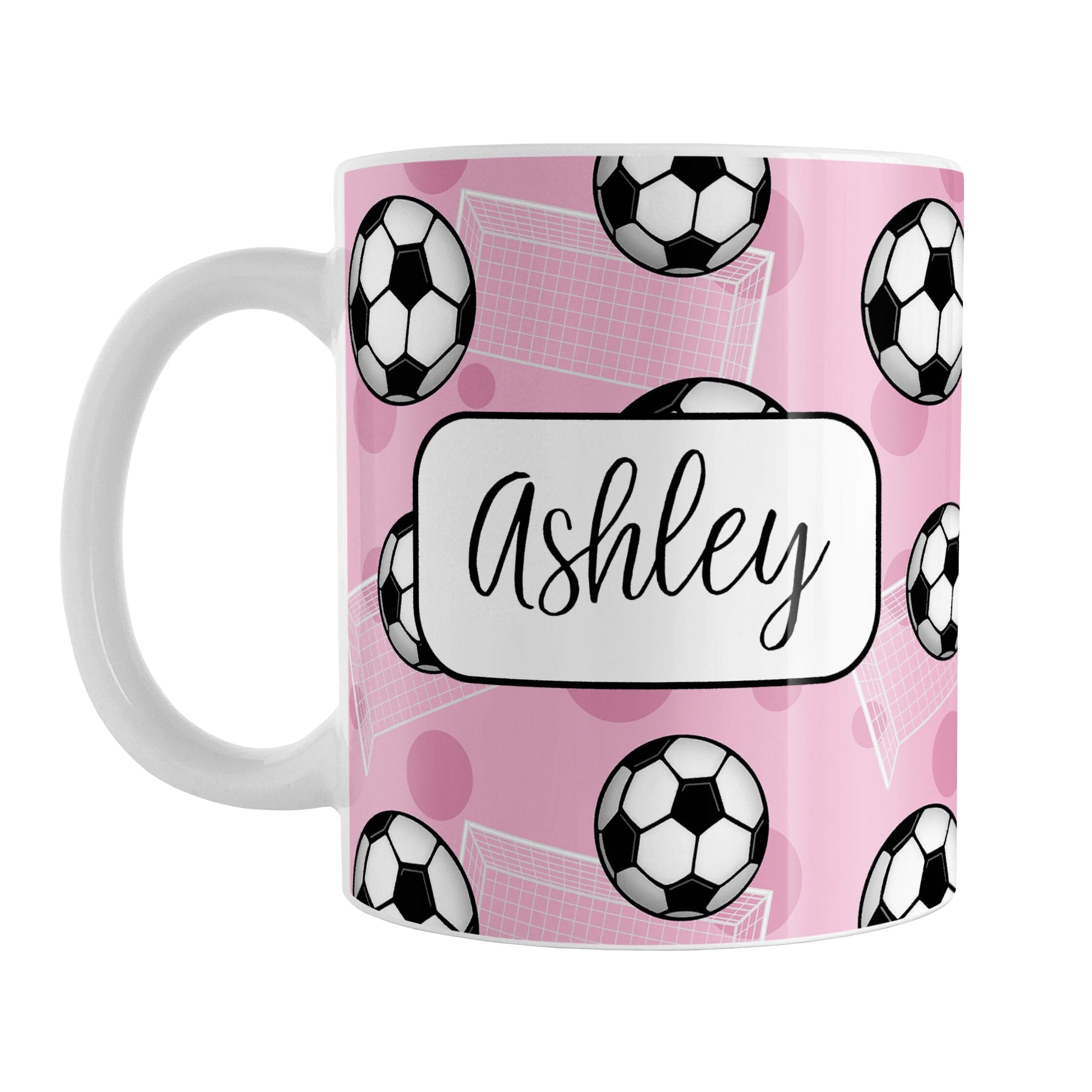 Soccer Ball and Goal Personalized Pink Soccer Mug (11oz) at Amy's Coffee Mugs. A ceramic coffee mug designed with a pattern of soccer balls and white soccer goals over a pink background with pink circles. Your personalized name is custom-printed in a fun black script font on both sides of the mug over the soccer pattern.