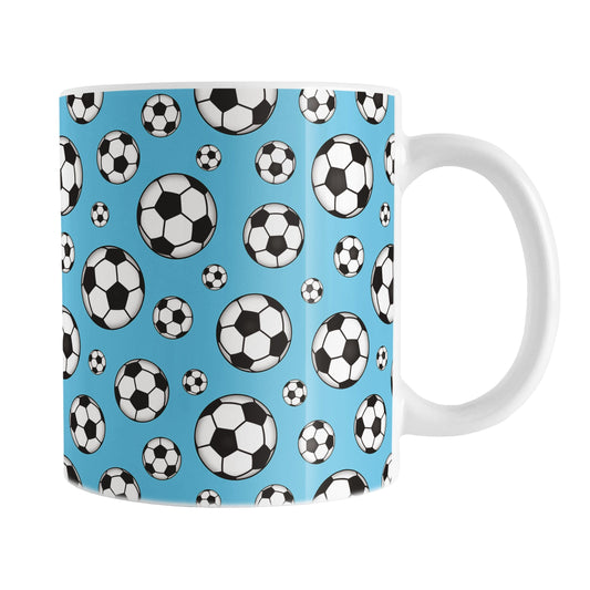 11oz white ceramic coffee mug with a pattern of soccer balls on a blue background