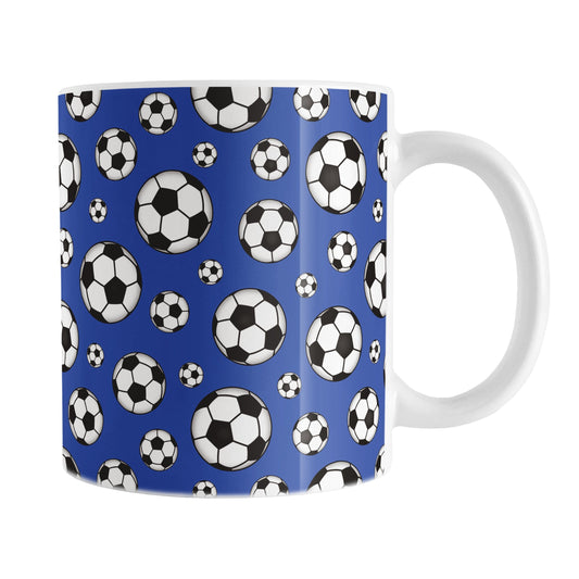 11oz white ceramic mug with a design of soccer balls over dark blue