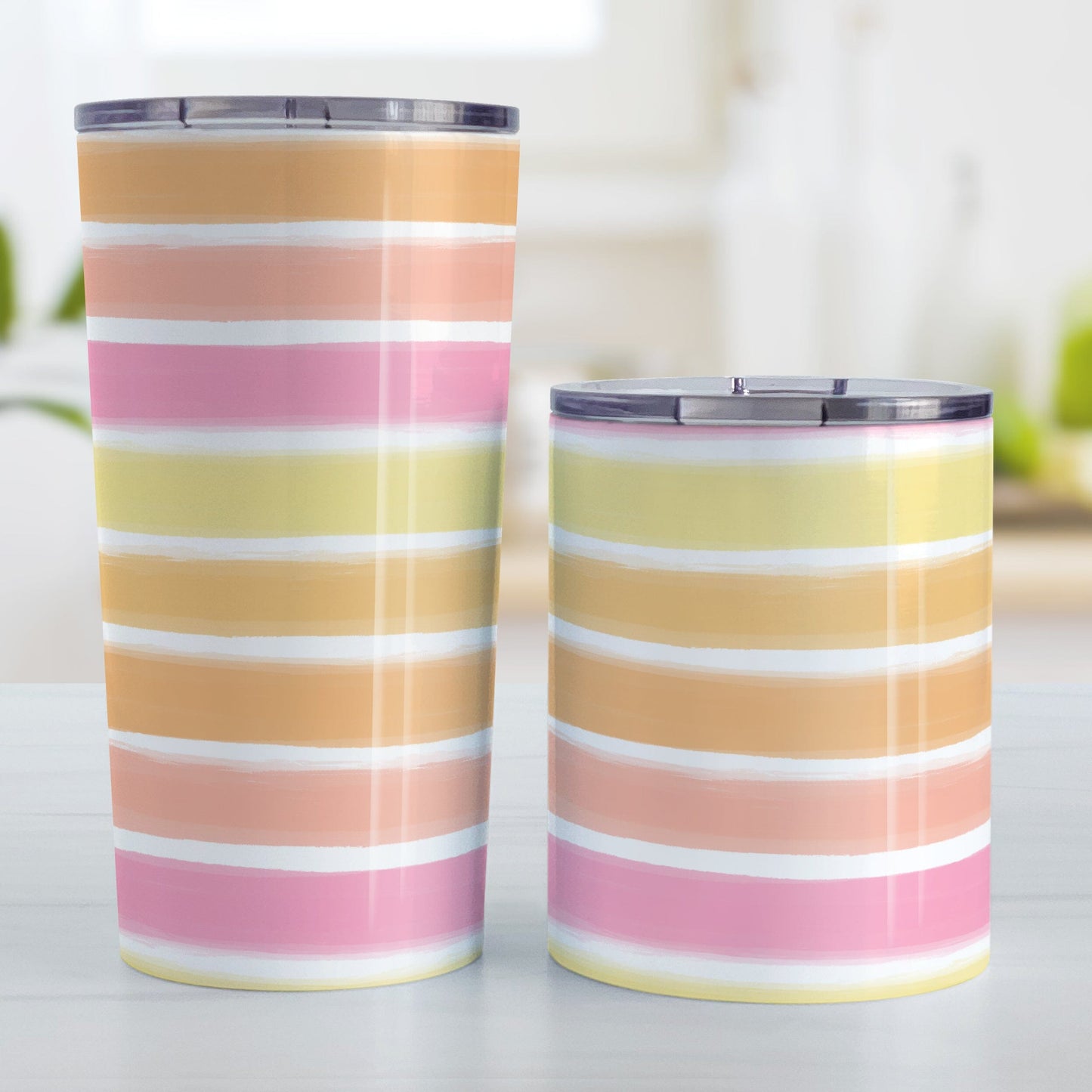 Warm Paint Strokes Tumbler Cups (20oz and 10oz) at Amy's Coffee Mugs. Stainless steel tumbler cups designed with a pattern of horizontal stripes done in a paint strokes illustration in warm colors that wraps around the cups. These warm colors include yellow, orange, peach, and pink tones. Photo shows both sized cups on a table next to each other.