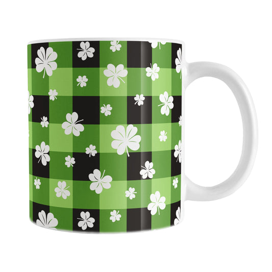 11oz mug with green and black checkered (buffalo plaid) pattern and white shamrocks and four-leaf clovers