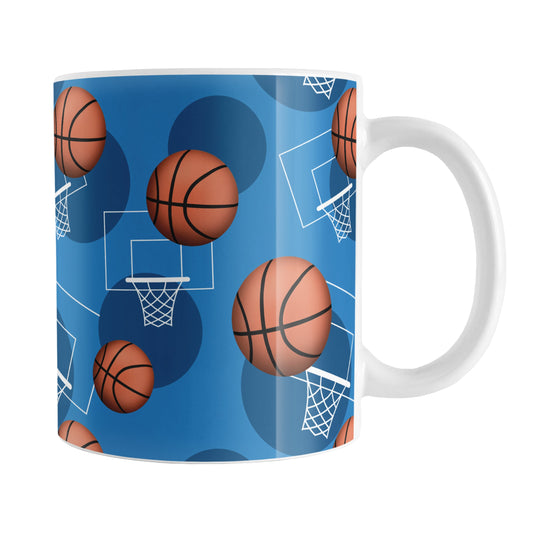 Basketball Themed Pattern - Blue Basketball Mug (11oz) at Amy's Coffee Mugs. A ceramic coffee mug designed with a sports themed pattern with basketballs and white hoops/nets over a blue colored background that wraps around the mug up to the handle.