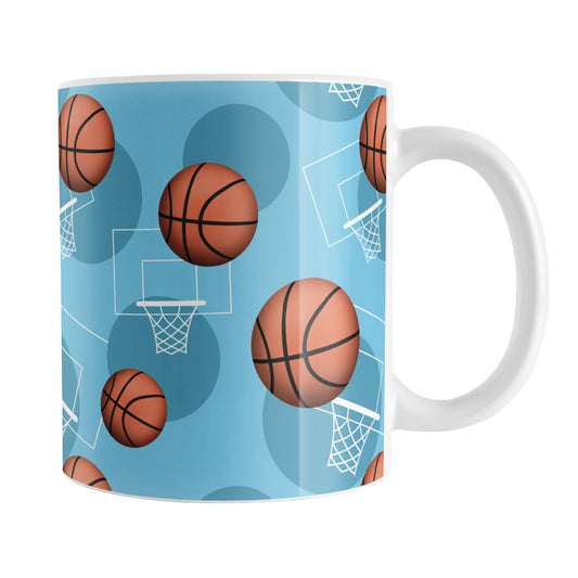 Basketball Themed Pattern - Light Blue Basketball Mug (11oz) at Amy's Coffee Mugs. A ceramic coffee mug designed with a sports themed pattern with basketballs and white hoops/nets over a light blue colored background that wraps around the mug up to the handle.