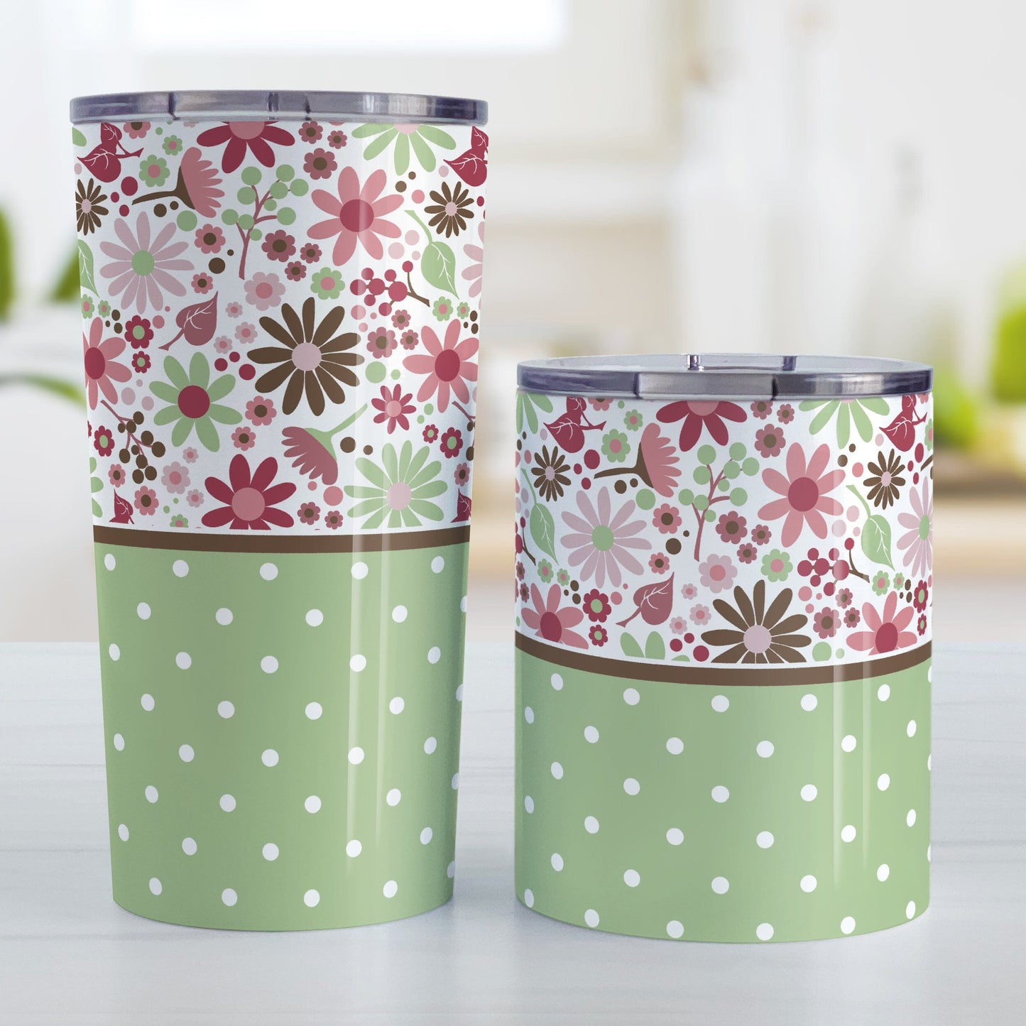 Berry Green Summer Flowers Polka Dot Tumbler Cups (20oz or 10oz) at Amy's Coffee Mugs. Stainless steel tumbler cups designed with a pretty floral pattern in a gorgeous berry pink color palette with sage green and brown along the top, and a sage green polka dot pattern along the bottom. These patterns wrap around the cups. Photo shows both sized cups on a table next to each other.