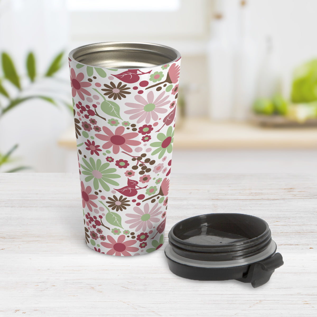 Berry Green Summer Flowers Travel Mug (15oz, stainless steel insulated) at Amy's Coffee Mugs. A travel mug designed with a lovely summer flowers pattern in beautiful berry pink hues, accented with green and brown, that wraps around the travel mug. Photo shows the mug open on a table with the lid beside it.