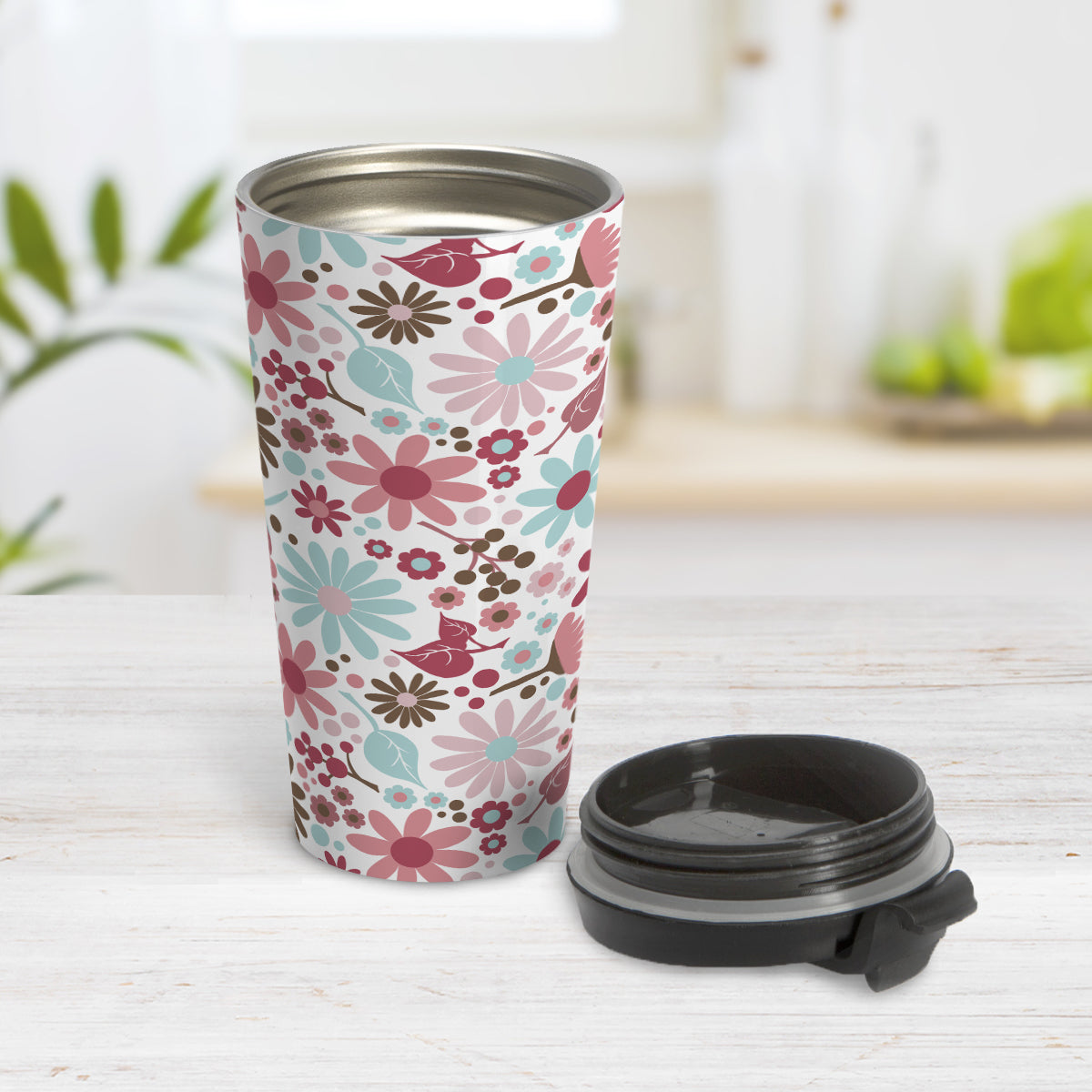 Berry Summer Flowers Travel Mug (15oz, stainless steel insulated) at Amy's Coffee Mugs. A travel mug designed with a lovely summer flowers pattern in beautiful berry pink hues, accented with aqua blue and brown, that wraps around the travel mug. Photo shows the travel mug open on a table with the lid beside it.