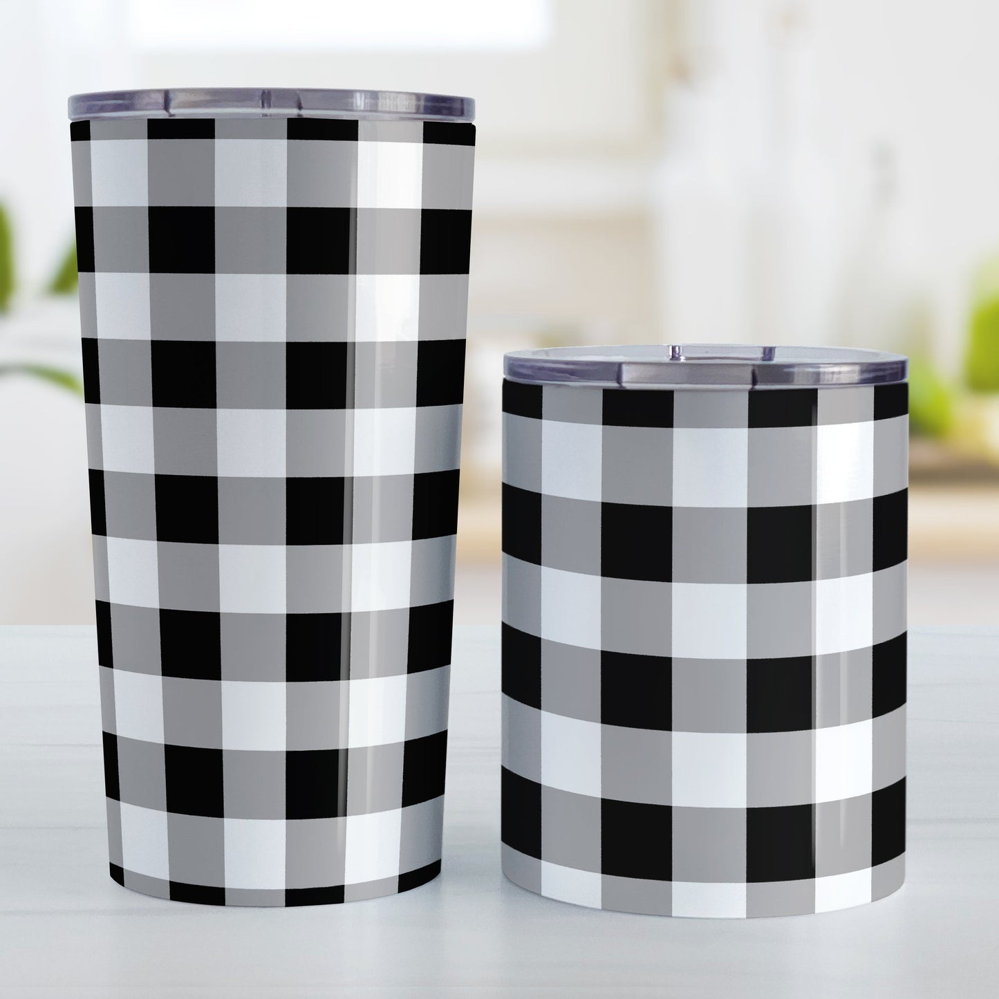 Black and White Buffalo Plaid Tumbler Cup (20oz and 10oz, stainless steel insulated) at Amy's Coffee Mugs. Tumbler cups designed with a black and white buffalo plaid (buffalo check) pattern that wraps around the cups. The photo shows both sized cups next to each other.