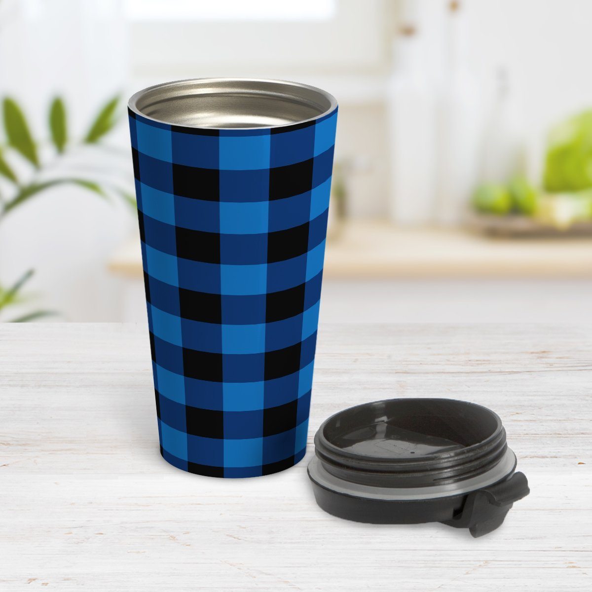 Blue and Black Buffalo Plaid Travel Mug at Amy's Coffee Mugs. A travel mug designed with a blue and black buffalo plaid (buffalo check) pattern that wraps around the travel mug. Photo shows the mug open on a table with the lid beside it.