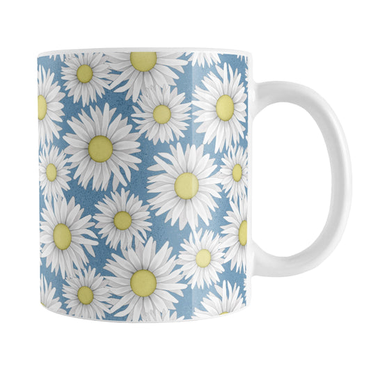Blue Daisy Pattern Mug (11oz) at Amy's Coffee Mugs. A ceramic coffee mug designed with a pretty pattern of white daisy flowers with yellow centers over a speckled blue background that wraps around the mug to the handle.