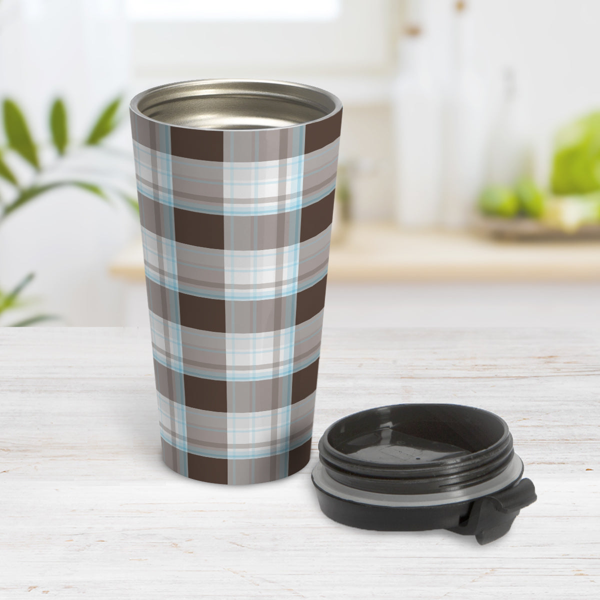 Brown Blue Plaid Travel Mug (15oz, stainless steel insulated) at Amy's Coffee Mugs. A travel mug designed with a traditional plaid pattern in varying shades of brown with accents of blue that wraps around the travel mug. Photo shows the mug open on a table with its lid beside it.