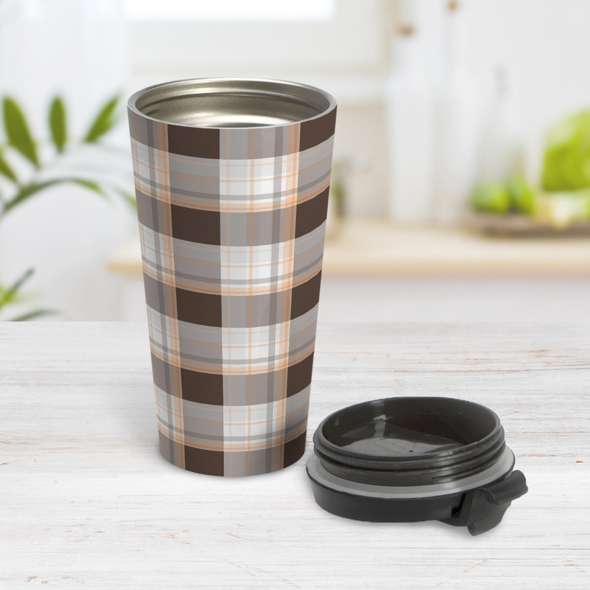 Brown Orange Plaid Travel Mug (15oz, stainless steel insulated) at Amy's Coffee Mugs. A travel mug designed with a traditional plaid pattern in varying shades of brown with accents of orange that wraps around the travel mug. Photo shows the mug open on a table with its lid beside it.