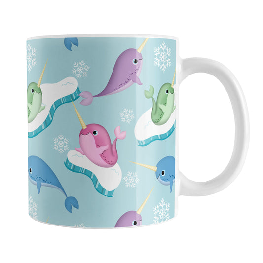 Colorful Arctic Narwhal Pattern Mug (11oz) at Amy's Coffee Mugs. A ceramic coffee mug designed pink, purple, blue, and green narwhals with icebergs and snowflakes over a light blue colored background that wraps around the mug up to the handle.