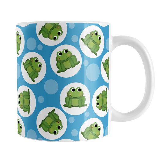 Cute Blue Frog Pattern Mug (11oz) at Amy's Coffee Mugs. A ceramic coffee mug designed with cute and smiling green frogs in white circles scattered over a blue background color in a pattern that wraps around the mug up to the handle.