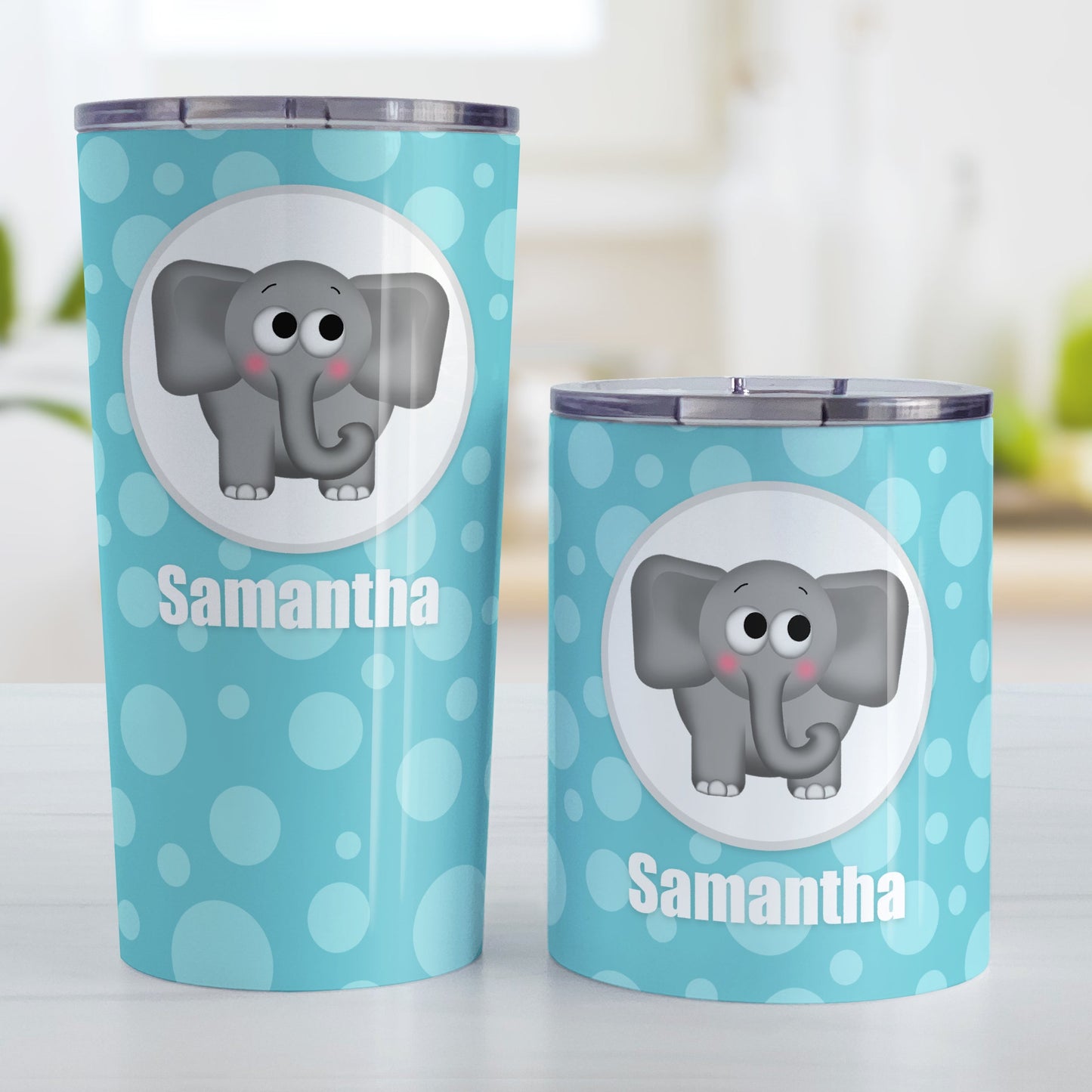 Cute Elephant Bubbly Turquoise Personalized Tumbler Cup (20oz and 10oz, stainless steel insulated) at Amy's Coffee Mugs. A tumbler cup designed with an adorable and affectionate gray elephant in a white circle outlined in gray over a turquoise bubbly background that wraps around the cup. Your name is personalized in white below the cute elephant. Photo shows both sized cups on a table next to each other.