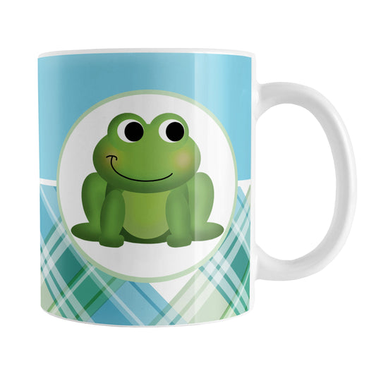 Cute Frog Green and Blue Plaid Mug (11oz) at Amy's Coffee Mugs. A ceramic coffee mug designed with a cute and smiling green frog on both sides of the mug over a background design that wraps around the mug up to the handle, with a solid blue color along the top and a blue and green plaid pattern along the bottom.
