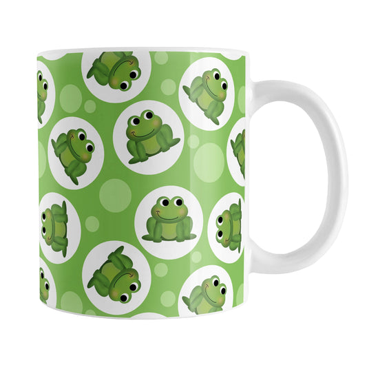 Cute Green Frog Pattern Mug (11oz) at Amy's Coffee Mugs. A ceramic coffee mug designed with cute and smiling green frogs in white circles scattered over a green background color in a pattern that wraps around the mug up to the handle.
