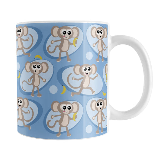Cute Blue Monkey Pattern Mug (11oz) at Amy's Coffee Mugs. A ceramic coffee mug designed with a pattern of fun and cute brown monkeys in light blue ovals with bananas over a blue background color that wraps around the mug up to the handle.