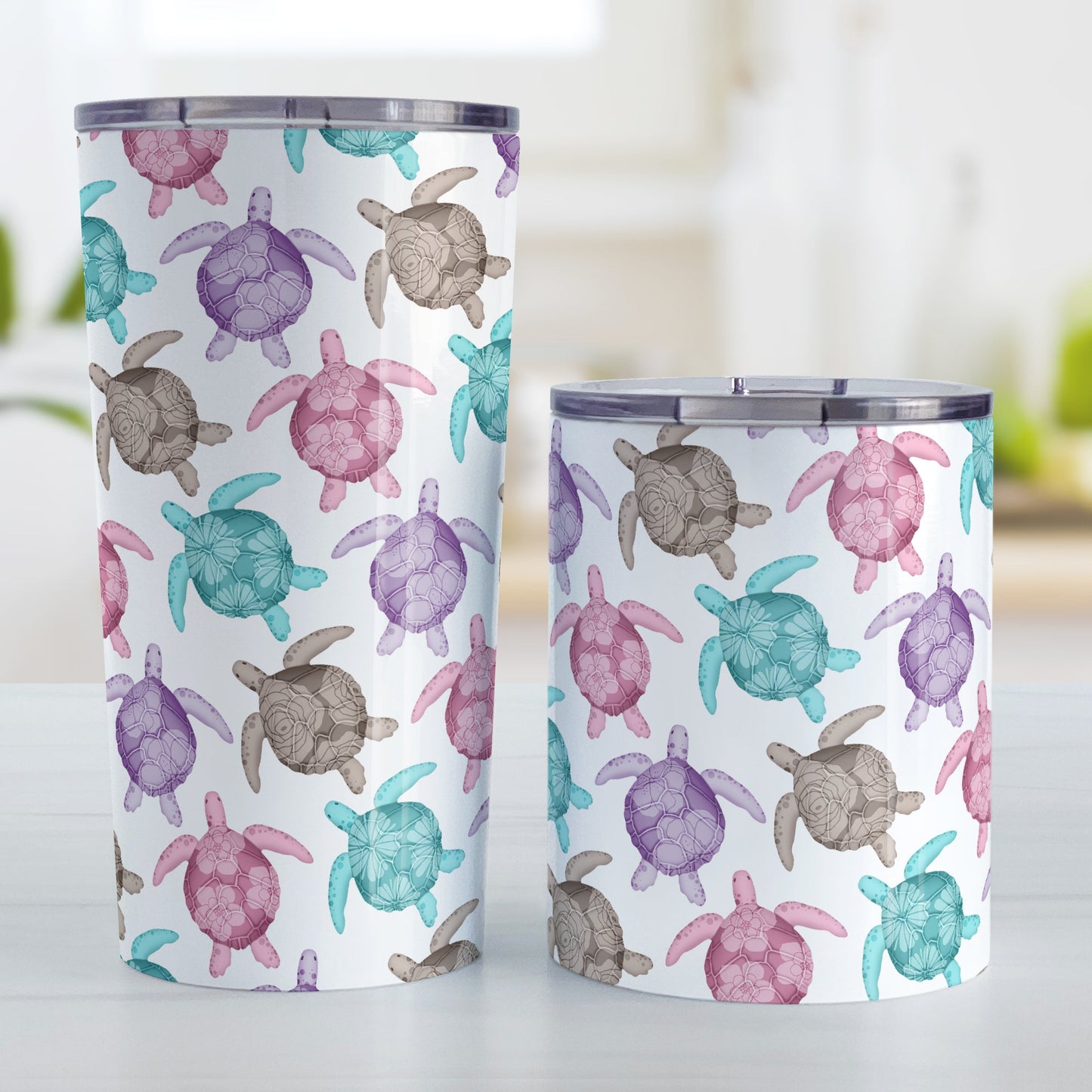 Cute Sea Turtles Pattern Tumbler Cup (20oz and 10oz, stainless steel insulated) at Amy's Coffee Mugs. Tumbler cups with a pattern of sea turtles in a cute color palette of pink, purple, teal and brown that wraps around the cups. Each cute-colored sea turtle has a different floral watermark over its shell. The photo shows both sizes of cups next to each other.