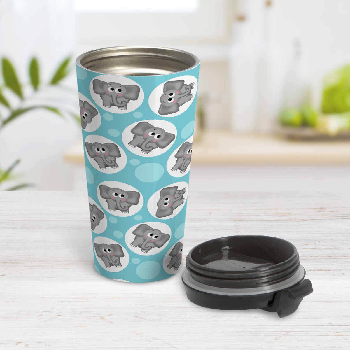 Cute Turquoise Elephant Pattern Travel Mug (15oz) at Amy's Coffee MugsCute Turquoise Elephant Pattern Travel Mug (15oz, stainless steel insulated) at Amy's Coffee Mugs. A travel mug designed with cute and affectionate gray elephants in white circles scattered over a turquoise background color in a pattern that wraps around the travel mug. Photo shows the mug open on a table with its lid beside it.