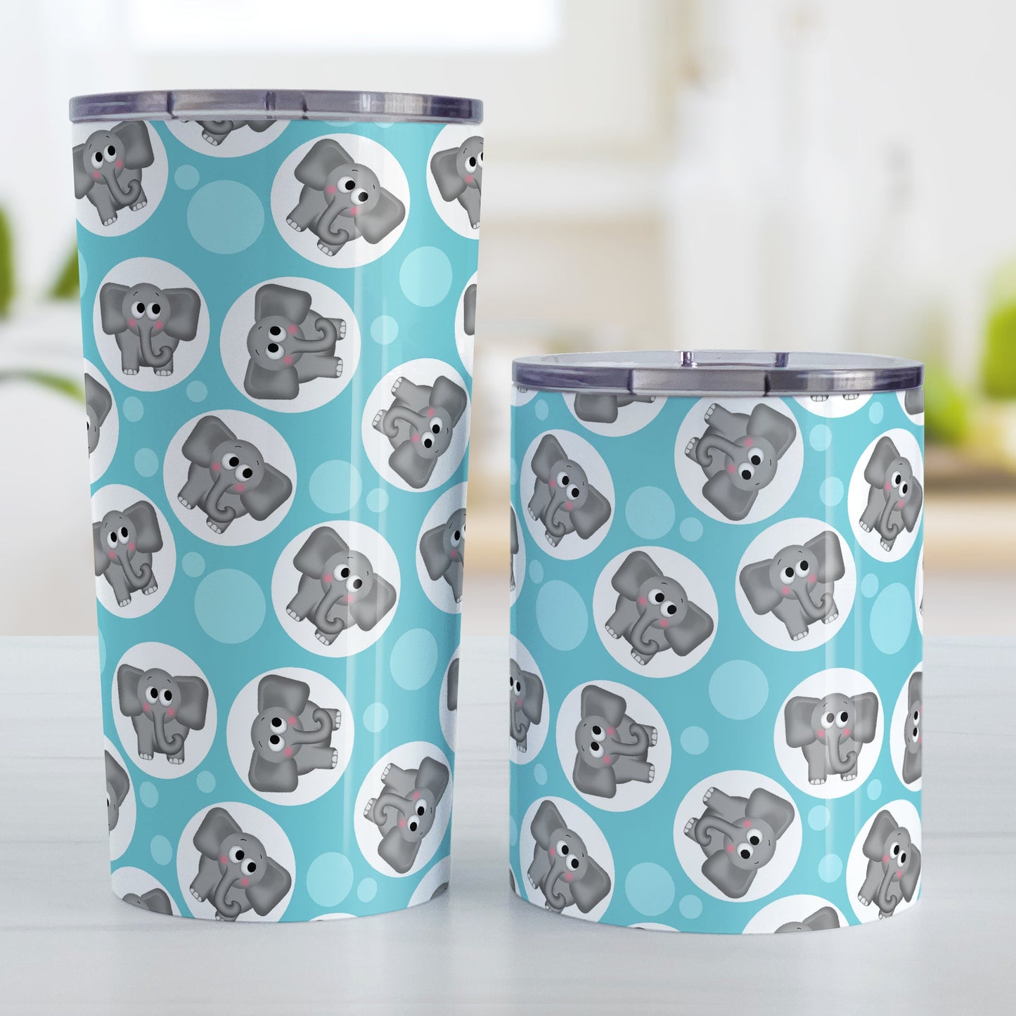 Cute Turquoise Elephant Pattern Tumbler Cup (20oz and 10oz, stainless steel insulated) at Amy's Coffee Mugs. Tumbler cups designed with cute and affectionate gray elephants in white circles scattered over a turquoise background color in a pattern that wraps around the cups. Photo shows both sized cups on a table next to each other.
