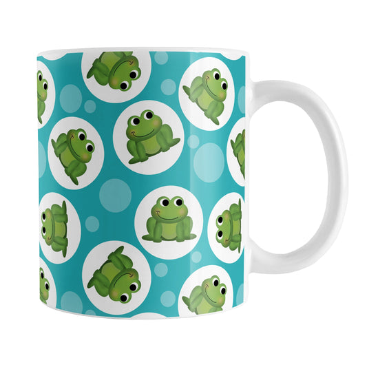 Cute Turquoise Frog Pattern Mug (11oz) at Amy's Coffee Mugs. A ceramic coffee mug designed with cute and smiling green frogs in white circles scattered over a turquoise background color in a pattern that wraps around the mug up to the handle.