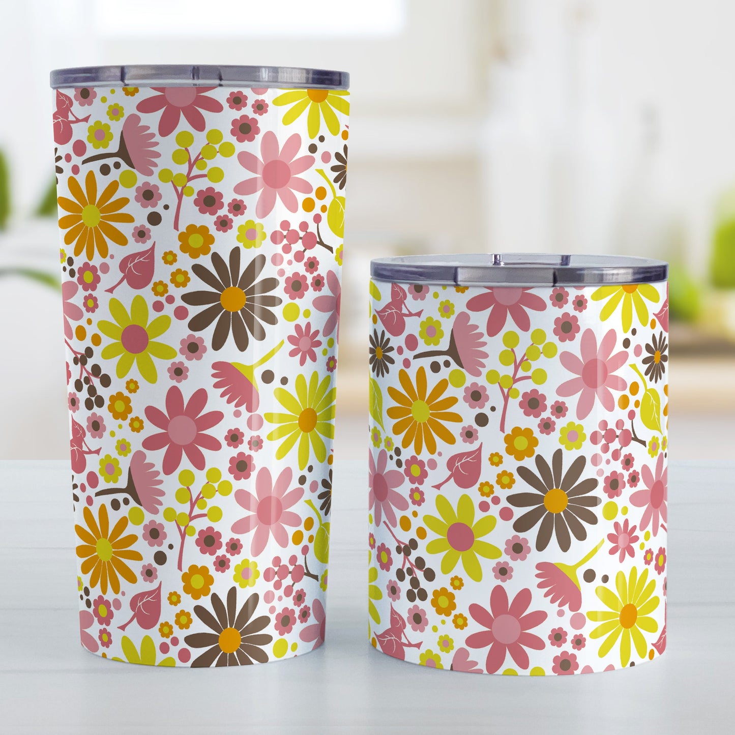 Fruity Summer Flowers Tumbler Cup (20oz and 10oz, stainless steel insulated) at Amy's Coffee Mugs. A tumbler cup designed with pretty fruity-colored flowers and leaves with berry pink, orange, yellow, and brown colors in a floral pattern that wraps around the cup. Photo shows both sized cups on a table next to each other.