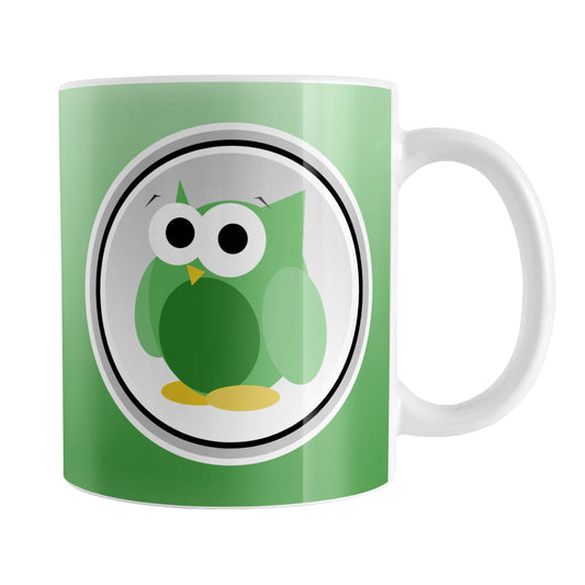 Funny Cute Green Owl Mug (11oz) at Amy's Coffee Mugs. A ceramic coffee mug designed with a funny and cute green owl in a white circle outlined in black and gray over a gradient green background color that wraps around the mug to the handle. The owl illustration is on both sides of the mug.