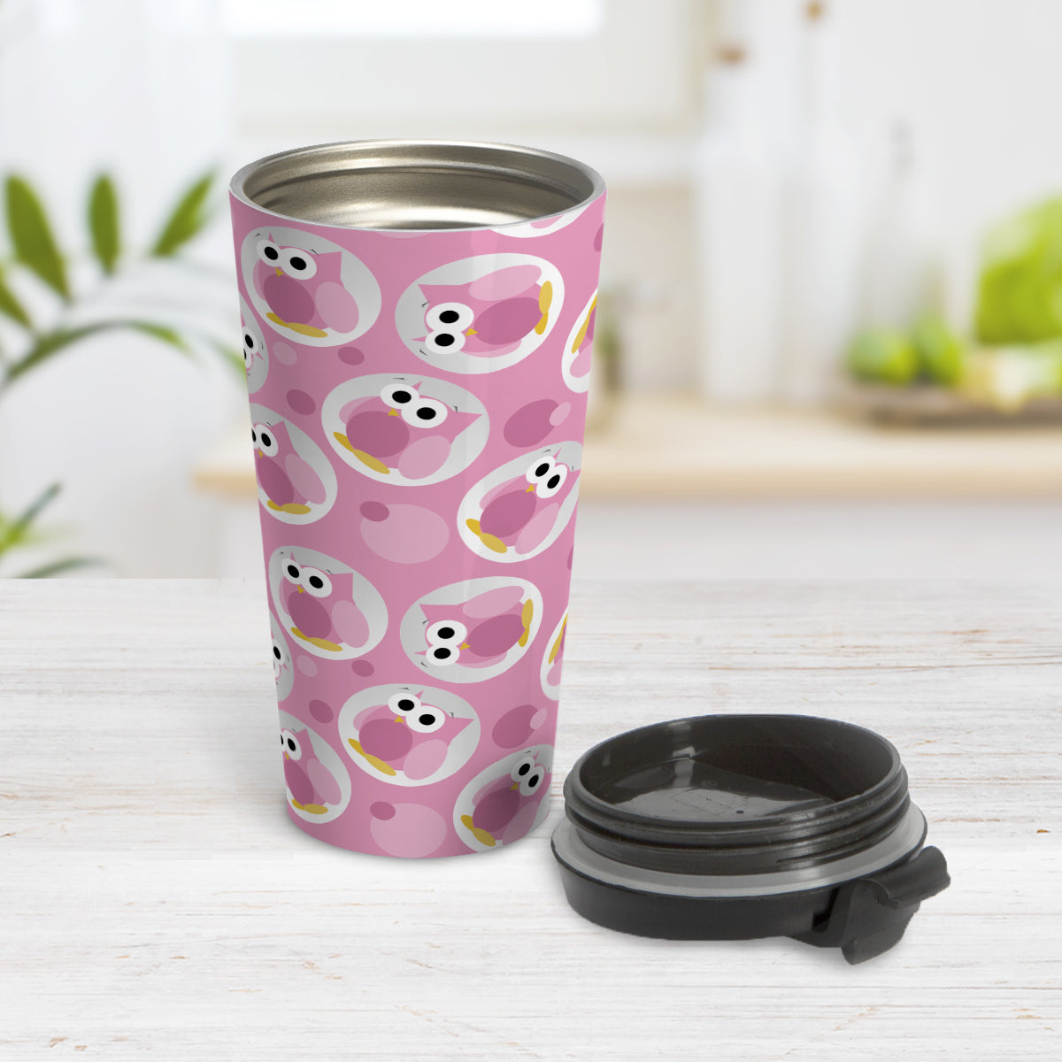Funny Cute Pink Owl Pattern Travel Mug (15oz, stainless steel insulated) at Amy's Coffee Mugs. A travel mug designed with a pattern of funny and cute pink owls in a light gray circles scattered over a pink background color that wraps around the travel mug. Photo shows the mup open on a table with its lid beside it.