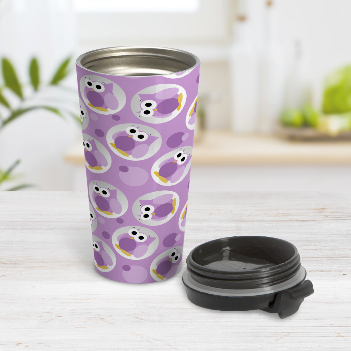 Funny Cute Purple Owl Pattern Travel Mug (15oz) at Amy's Coffee Mugs. A travel mug designed with a pattern of funny and cute purple owls in a light gray circles scattered over a purple background color that wraps around the travel mug. Photo show the mug open on a table with its lid beside it.