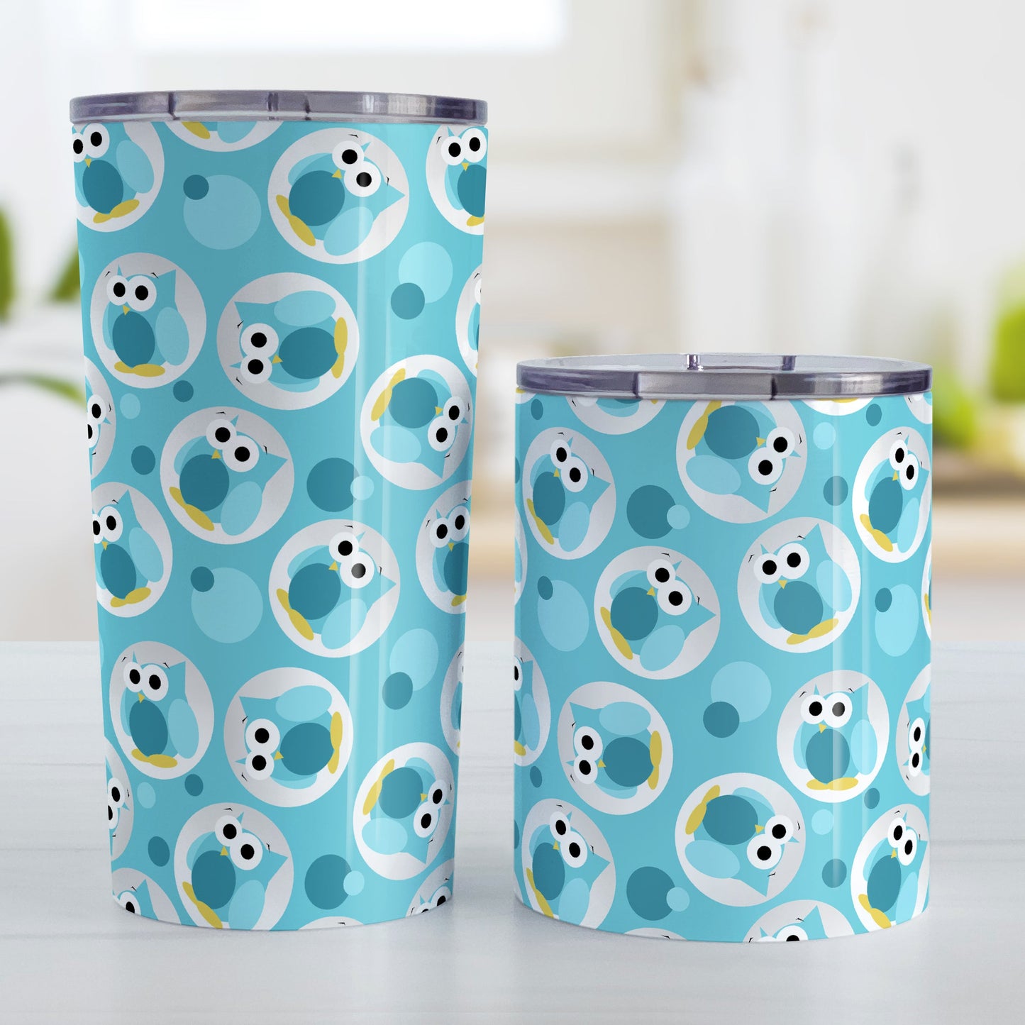 Funny Cute Turquoise Owl Pattern Tumbler Cup (20oz on 10oz, stainless steel insulated) at Amy's Coffee Mugs. A tumbler cup designed with a pattern of funny and cute turquoise owls in a light gray circles scattered over a turquoise background color that wraps around the cup. Photo shows both sized cups on a table next to each other.