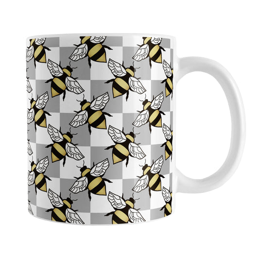 Gray Checkered Bee Mug (11oz) at Amy's Coffee Mugs. A ceramic coffee mug designed with a gray and white checkered pattern adorned with alternately facing bees over the check pattern. This design wraps around the mug up to the handle.